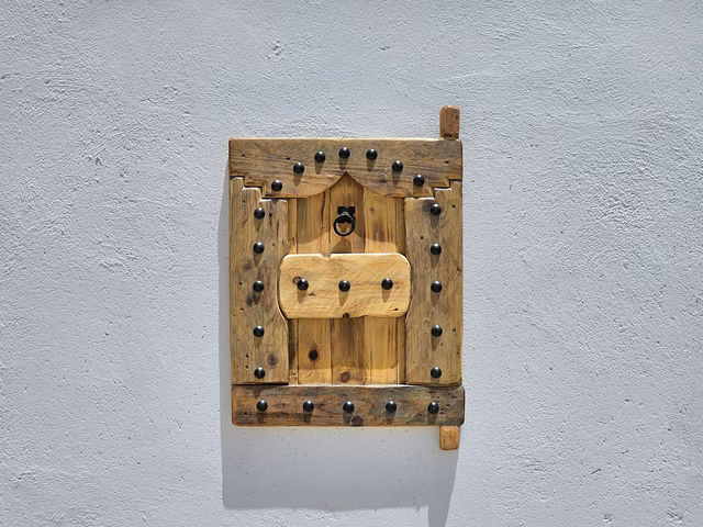 Amazigh Carved Wood Wall Panel 63×51 cm – Door Form with Iron Studs